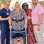 group of four posing in healing garden
